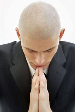 Tips and advice how to dress for a funeral - young man praying.